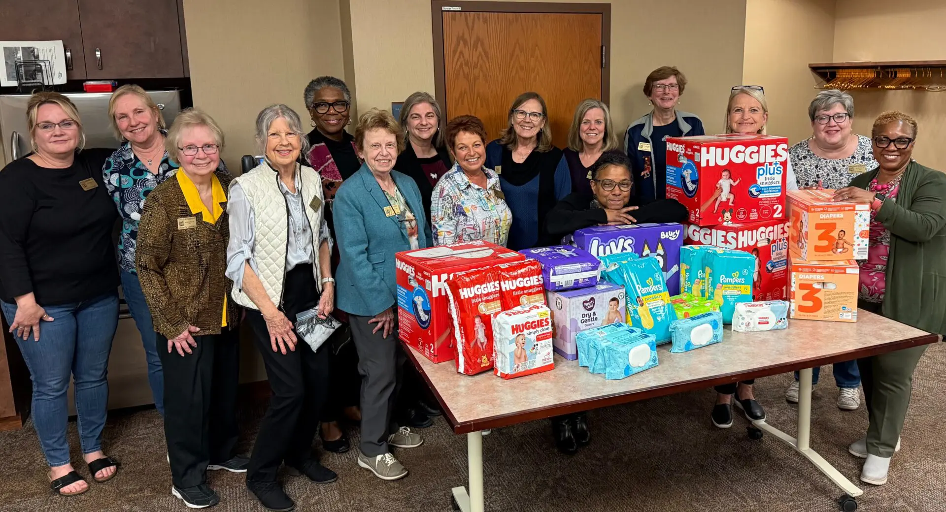 Group of women with donated diaper supplies.