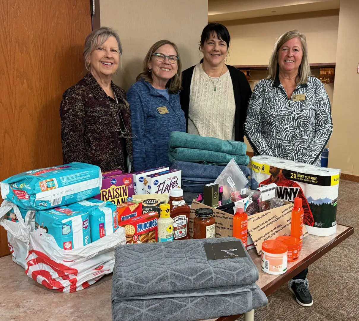 Four women with donated household items.