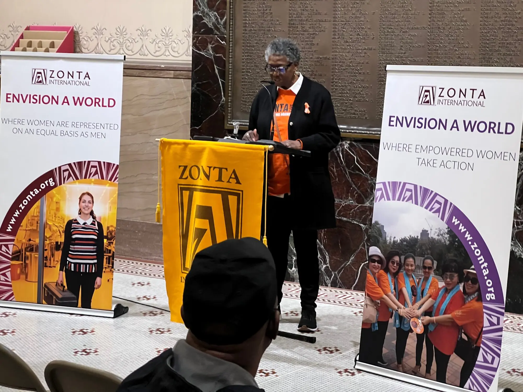Speaker delivering a presentation at a Zonta International event.
